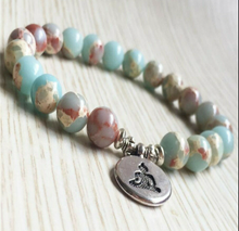 Load image into Gallery viewer, Aqua Sea Sediment December Birthstone Bracelet with Seated Buddha Charm