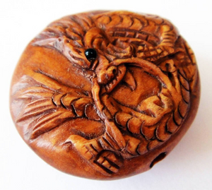 Dragon Ojime Bead in a round pillow shape.