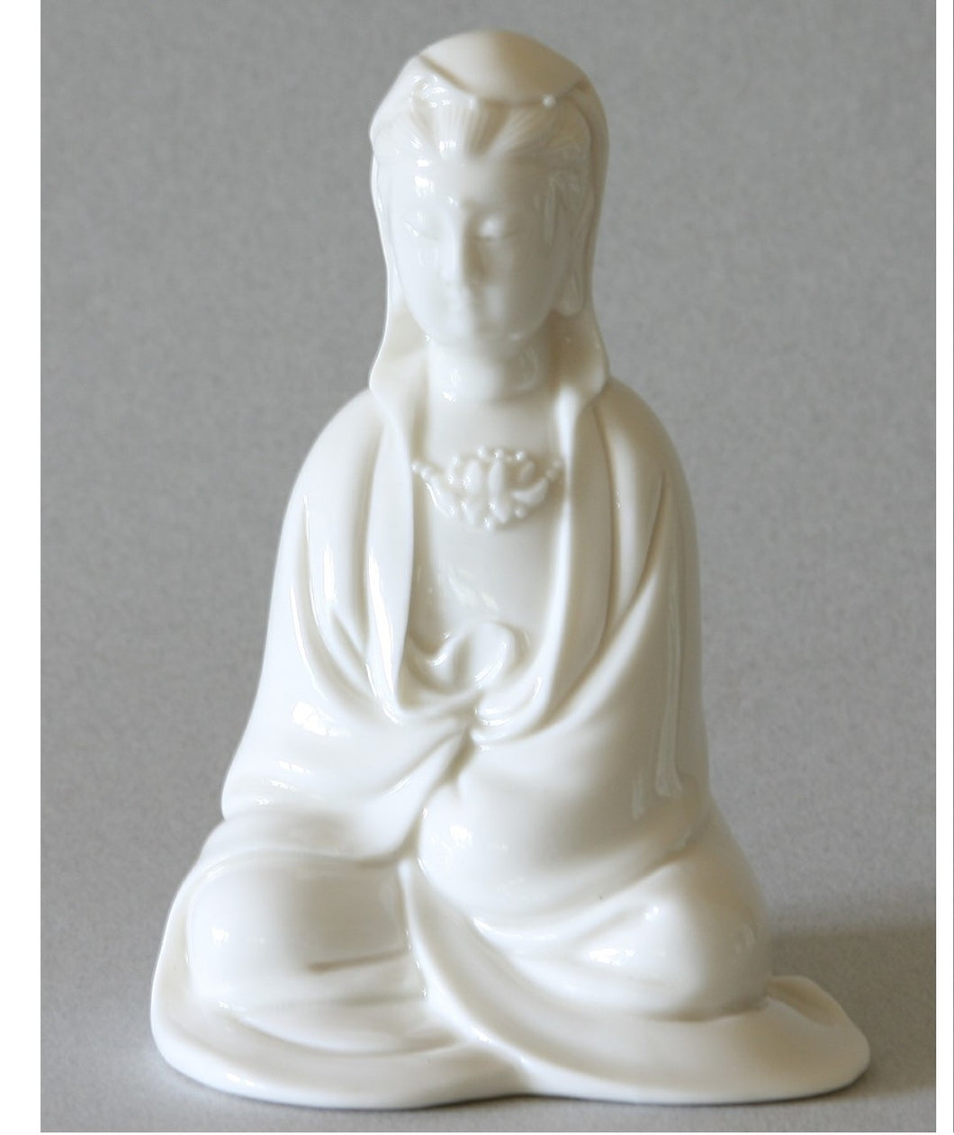 Seated Kwan Yin figurine in Cloak Blanc de Chine