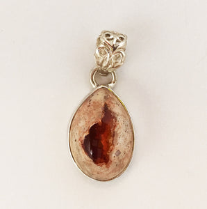Mexican Fire Opal pendant in oval-ish sterling silver frame