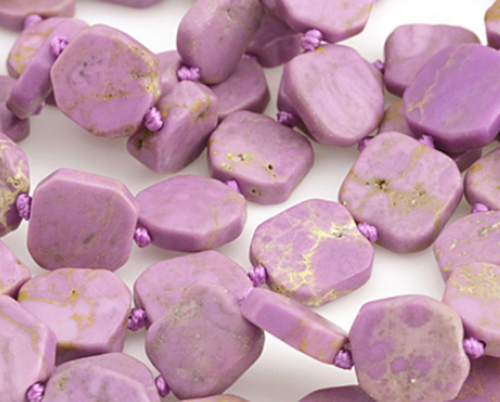 Phosphosiderite beads comprised of polished sliced nuggets.