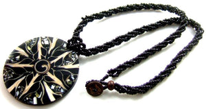 Black Cone Shell, Shiva Shell and Abalone Shell Medallion on black beaded rope.