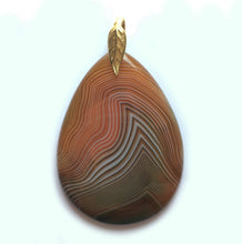 Load image into Gallery viewer, Orange and Brown Onyx pendant in a pear shape with gold plated leaf bail.