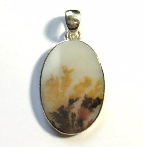 Dendritic Agate pendant in sterling silver frame has a sepia background scene